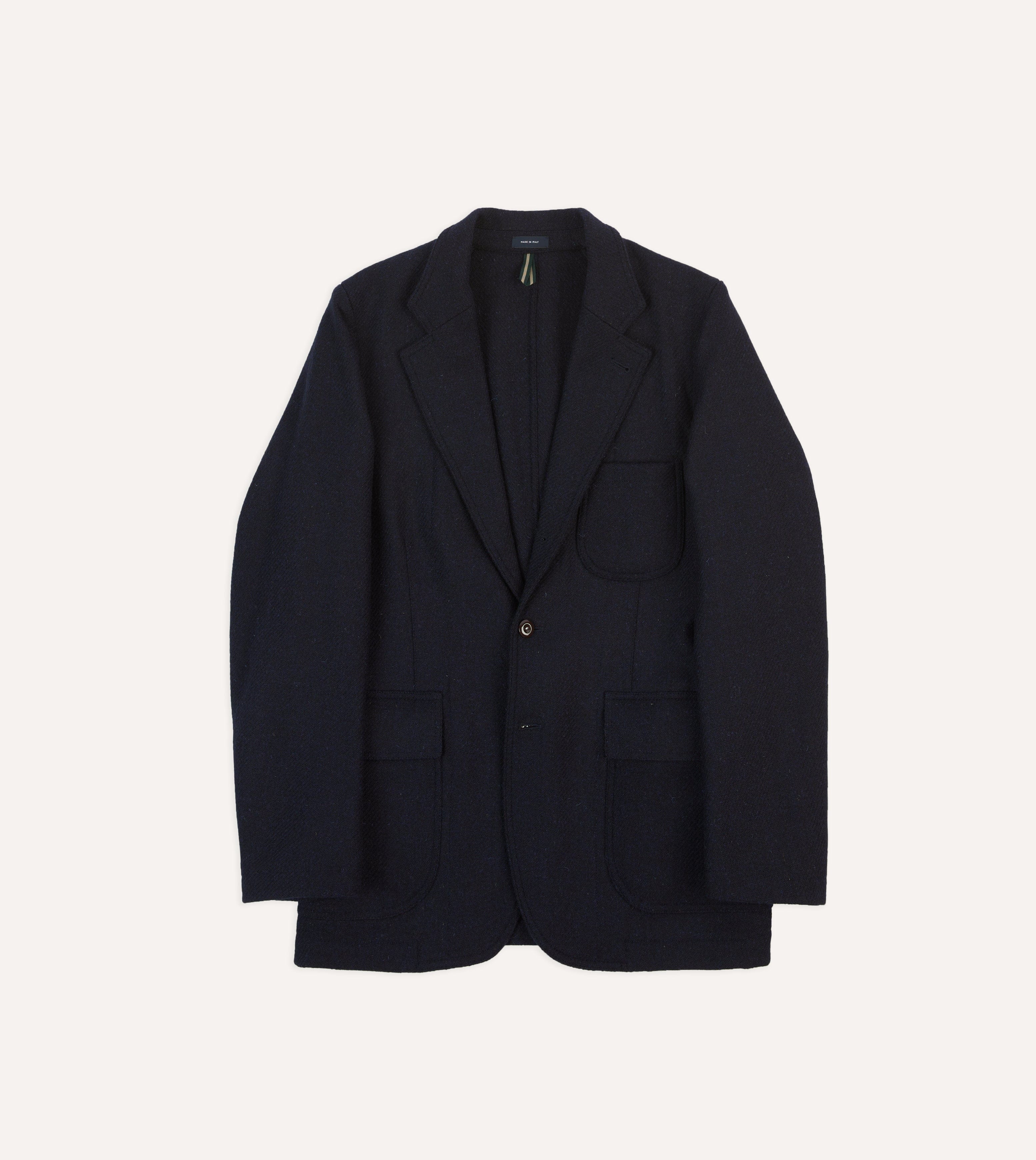 A navy Harris Tweed blazer with patch pockets, shown from the front.